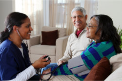 caregiver with two elderly